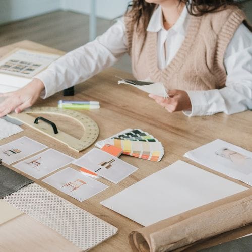 logo development and paint swatches on a desk representing logo design